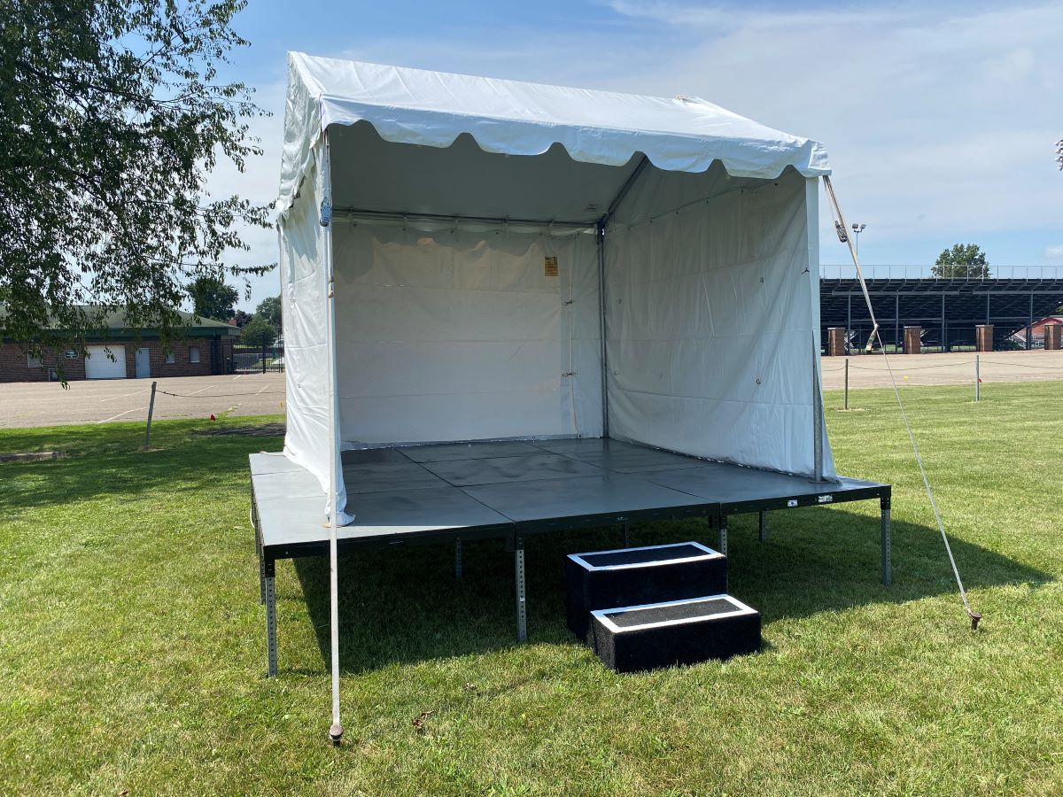10x10 Marquee Frame Tent on 12x12 Wood Topped Stage 25 1/2" Tall with Double Step and Solid Tent Sides